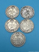 Reverse of all five Canadian 5-cent coins showing dates and wreath design
