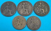 Overview of five British coins on blue background
