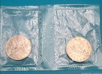 Two sealed 1968 Voyageur dollars in mint pliofilm