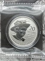 Obverse view of coin in capsule displaying Queen Elizabeth II design and inscriptions