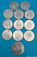 Group shot of 11 fifty-cent coins and one 1969 dollar