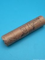 Full view of sealed brown paper roll marked 50 Pennies