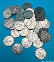 Pile of mixed-date Canadian 5-cent coins showing obverse and reverse