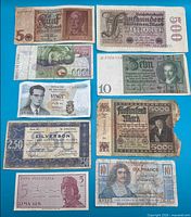 Overview of all nine banknotes laid out on blue background