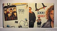 Both INXS LPs front covers side by side