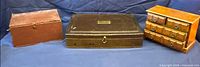 Group view of three wooden boxes: canteen, storage box, miniature chest