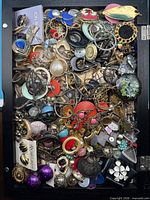 Full tray view showing large quantity of mixed jewelry