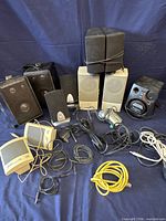 All speakers and cables laid out on blue backdrop