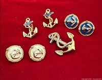 All earrings and brooch on red background