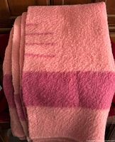 Folded salmon wool blanket showing darker band and point lines