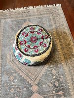 Top view of embroidered cotton pouf showing overall pattern and shape