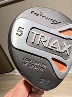 Sole of club head showing Callaway Triax branding, 21° loft, low center of gravity text