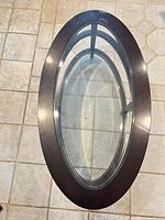 Top view of oval wood frame with glass insert