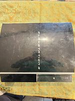 Top view of Sony PlayStation 3 fat console showing cosmetic wear and PLAYSTATION 3 logo