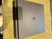 Top view of PS4 Slim showing PlayStation logo and overall surface