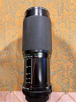 Lens standing upright showing front filter, focus ring and general exterior