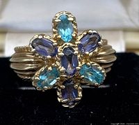 Front view of ring showing gemstone arrangement and gold setting