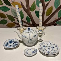 Group view showing teapot, dishes, candles and holders
