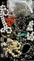 Top view of assorted necklaces and bracelets in tray
