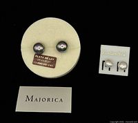 Front view showing both pairs of earrings on display cards