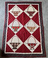 Full view of handmade basket pattern quilt showing overall design and colors