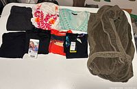 All seven folded garments displayed on table