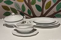 front view of entire white porcelain serving set