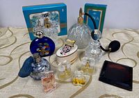 Group shot showing all perfume bottles, atomizers, compacts and boxed items