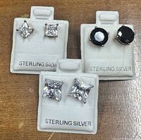 Front view three pairs sterling silver CZ stud earrings on cards