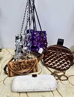 All five bags displayed: silver sequin, purple sequin, bronze quilted, tan tooled leather, off-white woven