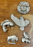Group view of all five pewter brooch pins