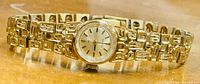 Front view of Seiko gold-tone watch on bracelet
