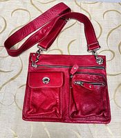 Front view showing bag, strap, front pockets