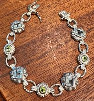 Full view of the bracelet on wood surface showing stone arrangement and toggle clasp