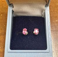 Both pink topaz stud earrings in box, frontal view