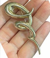 front view of brooch showing abstract swirl design