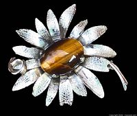 front view showing entire brooch with tiger eye center and textured petals