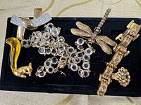 All six jewelry pieces arranged on black tray