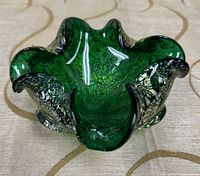 Top view showing ruffled form, green core, gold flecks