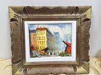 Framed oil on canvas cityscape painting front view