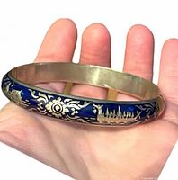 Full view of blue enamel Siam sterling bangle on hand