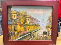 Front view of framed Paris street scene painting