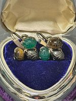 Front view showing both earrings with six carved scarabs