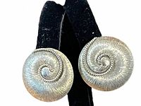 Front view of both earrings showing swirl design