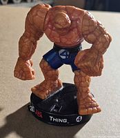 Front view of The Thing figure on Attacktix base showing name, team symbol, dial