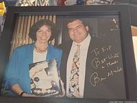 Framed autographed photo showing inscription and frame