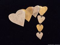 Front view showing alternating sterling and brass hearts