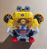 Front view of assembled LEGO submarine showing cockpit, robotic arms, and minifigure inside