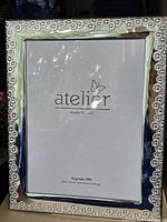 Front view of Atelier fine-silver frame displaying floral border details