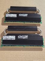 Both OCZ memory modules front view showing labels and heat pipe loops.